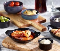 Black Oven-to-tableware with food.